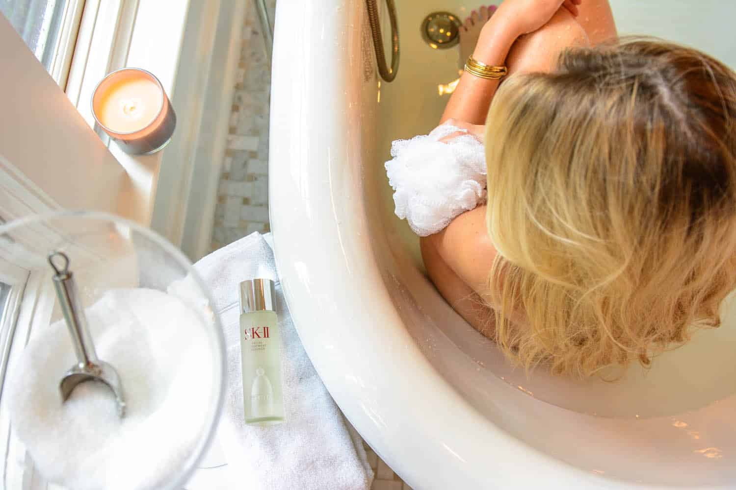 summer skincare routine while applying SK-II in the bathtub