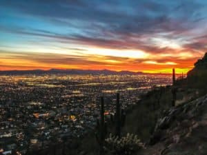 Lesley Murphy takes a photo of Scottsdale from Camelback Mountain at night