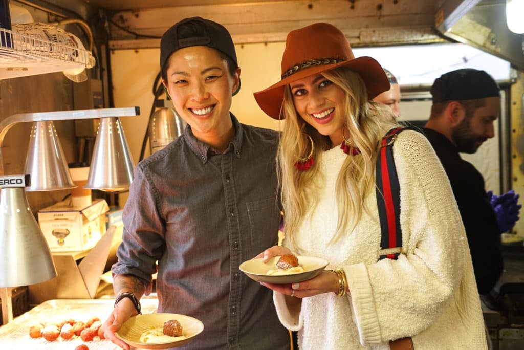 Lesley Murphy and Kristen Kish eating donuts in the Chase Sapphire Food Truck