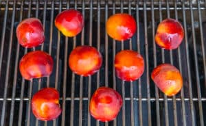preparing peaches to be grilled