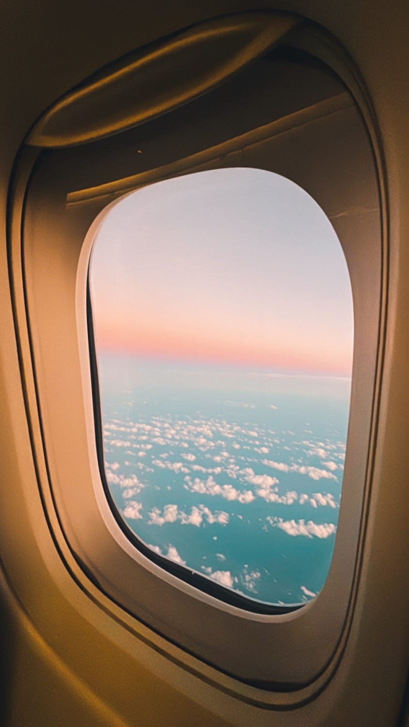 Plane window overlooking clouds