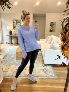 Lesley 2 weeks postpartum in the blue everyday crewneck from addison bay, leggings, and hokas